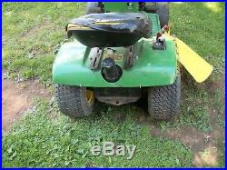 John Deere 111 riding mower with deck, snow plow, and chains