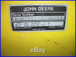John Deere 111 riding mower with deck, snow plow, and chains