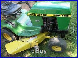 John Deere 111 riding mower with deck, snow plow, and chains. Needs engine work