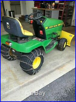 John Deere LX176 Lawn Tractor with lawn deck, plow. Chains and weights